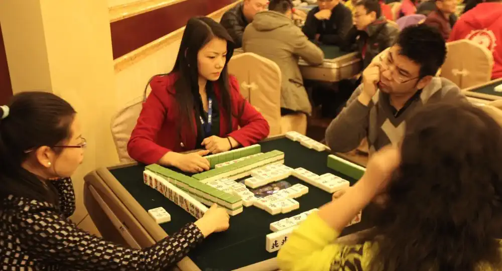 Orang-orang yang sedang bermain Mahjong tradisional